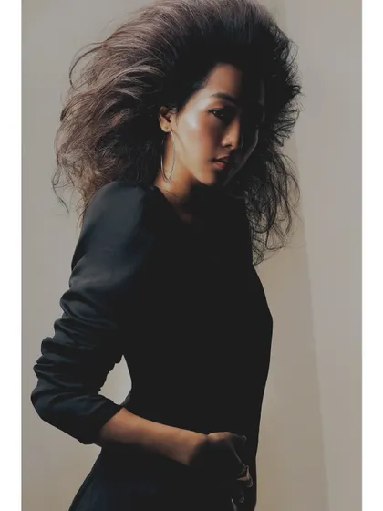 This image from the "Patricia" series uses shadow to create a sense of mystery and drama. The light just catches the side of her face, highlighting her expression and the texture of her hair.