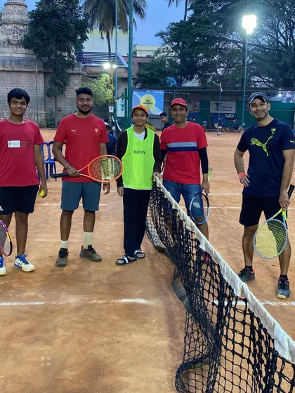 A team poses for a photo at the net during the December 2022 TTPL. These moments of camaraderie are just as important as the matches themselves.