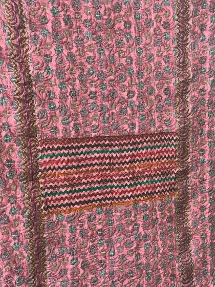 A collection of reversible memory quilts crafted from the sarees of a client's mother. Each side tells a different story, preserving the fabric's patterns and colors in a new, functional form.