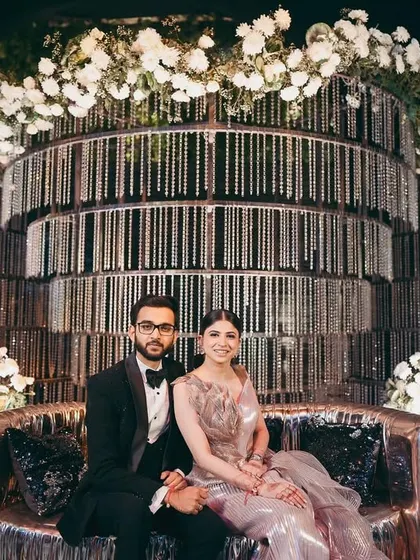 Shikha and her partner at their glamorous cocktail event in Raipur. Her metallic Amit Aggarwal gown was paired with a sophisticated updo and a soft smoky eye.
