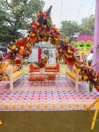 The Haldi seating area, designed with a colorful arch and geometric-patterned flooring, ready for the couple to be showered with love and turmeric.