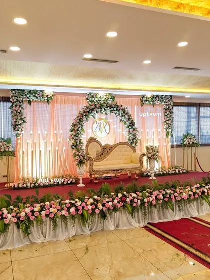 A wide shot of the engagement stage with a red carpet aisle.