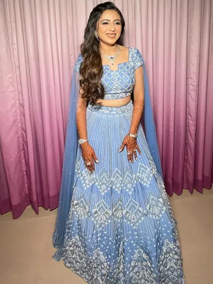 A beautiful sangeet look in a powder blue lehenga. I styled the hair in soft waves with a simple twist at the back.