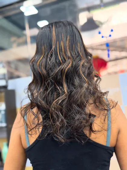 A view from the back showing the beautiful, beachy waves and how the Caramel Highlights catch the light.