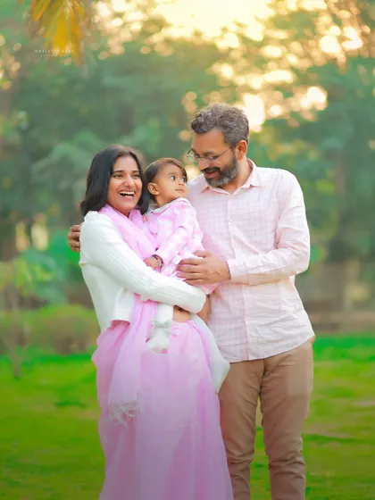 Capturing a moment of pure joy between parents and their child during a first birthday outdoor session. The soft, golden light makes this family portrait feel warm and full of love.