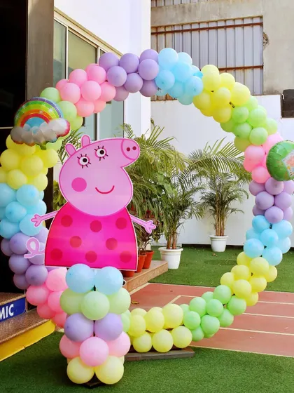 A circular balloon photo frame with a large Peppa Pig cutout. It's a fantastic spot for kids and families to take memorable pictures.