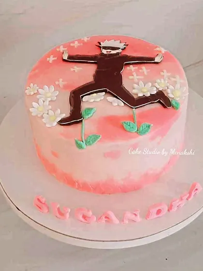 A Japanese anime themed cake for a fan. This no-fondant pink cake features a popular anime character for a unique and personal birthday celebration.