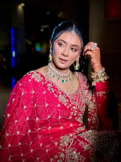 A close-up of the bride's soft glam makeup, with shimmery pink eyeshadow and perfectly defined features.