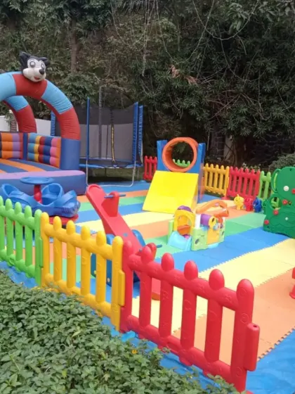This outdoor play area combines a bouncy castle, a trampoline, and various climbers and slides. It’s a great example of a comprehensive package that offers a wide variety of physical activities for energetic kids.