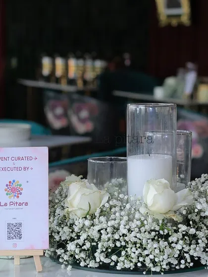 Another view of the candle and floral centerpiece, a simple yet incredibly effective way to add elegance and ambiance to any table setting.
