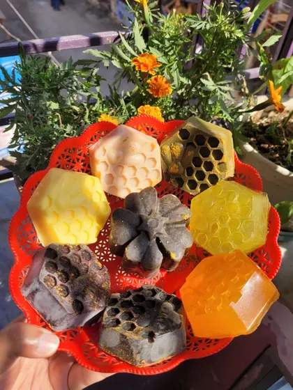 A variety of my facial soaps, showcasing the different shapes and natural ingredients like honey, charcoal, and ubtan.