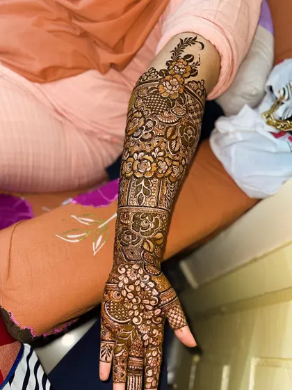 A beautiful floral bridal henna design covering the full arm. The patterns are dense and rich, perfect for a bride's big day.