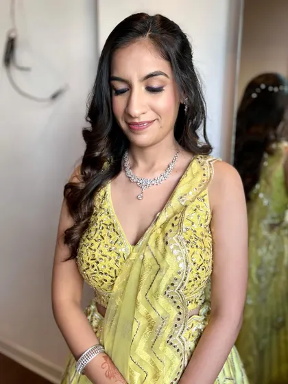 A winged purple shimmer eyeliner for this client's Mehendi look. It's a fun way to add a pop of color.