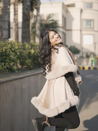 A playful and happy shot in my winter cape. Your clothes should make you feel this good.
