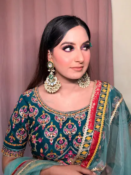 A three-quarter profile view that highlights the cheek contour and the seamless blend of the purple eyeshadow. This is a great makeup style for evening events.