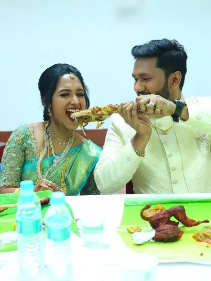 The bride and groom sharing a piece of roasted meat from their Raja Virundhu spread. We love being a part of these happy celebrations.