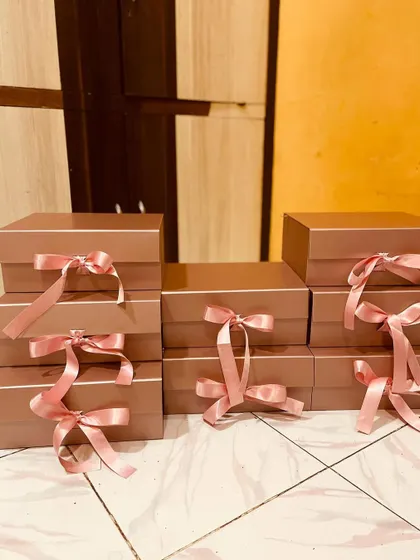 The calm before the storm. Here are the empty rose gold boxes, all tied with pink ribbons, ready to be filled with custom gifts for a bride's squad.