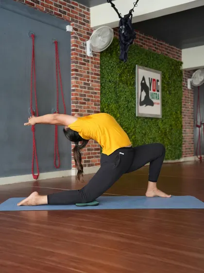 A deep low lunge backbend (Anjaneyasana). This pose is a fantastic preparation for deeper backbends, as it opens the hip flexors and begins to arch the spine.