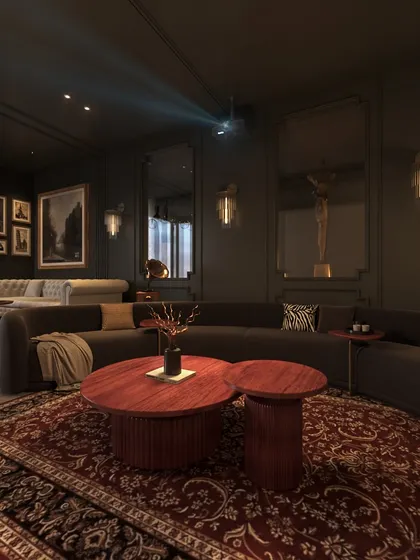 The projector is discreetly mounted on the ceiling, casting an image onto a large screen. The dark walls and plush furnishings create an immersive home theatre experience.
