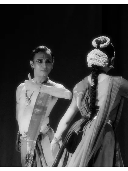 A black and white shot of a duet from "Tyāgarāja Hṛt Sādana." The lack of color focuses the viewer's attention on the emotional connection and interaction between the dancers.