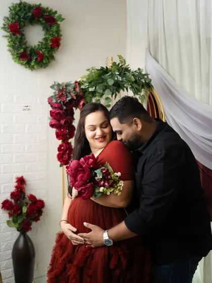 A tender embrace between the couple. This pose is perfect for capturing the love and support they share as they await their little one.