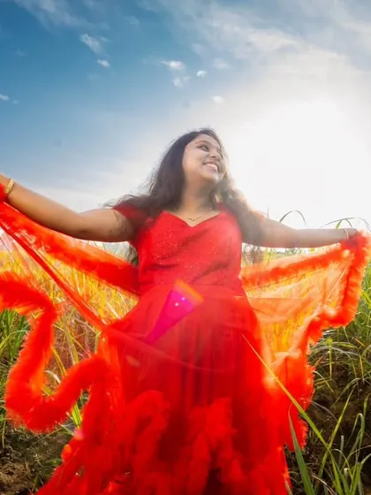Our red ruffle gown with detachable sleeves looks amazing in outdoor settings, like this sunny field.