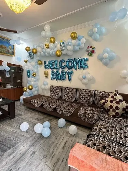 This wide shot shows how the "Welcome Baby" decoration can fill a living room space, creating a festive atmosphere for the family.