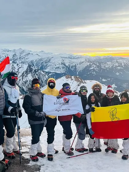 This is what pure joy and achievement look like. Our group at the Kedarkantha summit, proudly holding the flags high. We handle all the logistics so you can focus on moments like this.