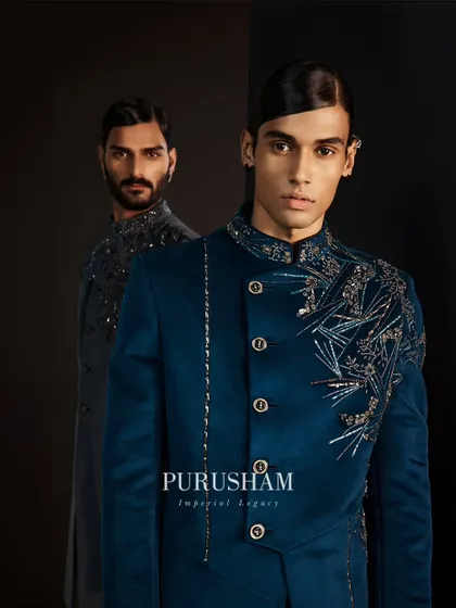 Class-apart designs for excellence beyond comparison. This teal velvet jacket features asymmetrical silver embroidery, creating a look that is both modern and timelessly regal.