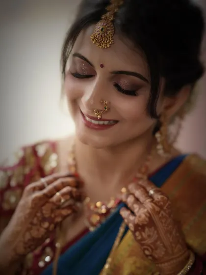 A close-up capturing a moment of quiet reflection. The soft, shimmery eye makeup and natural lip color create a gentle and romantic bridal look.