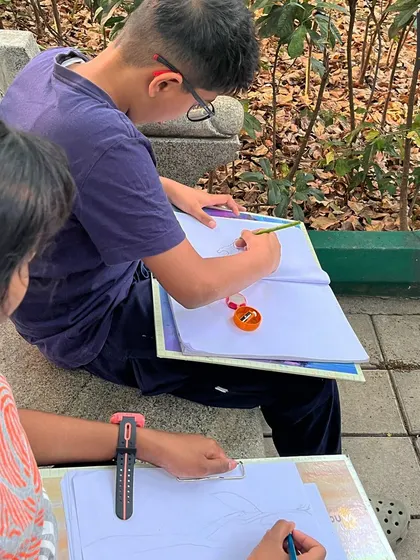 We often take our sketchbooks outdoors. Here, students are practicing observational sketching in a local park, learning to capture the forms and textures of nature directly from life.