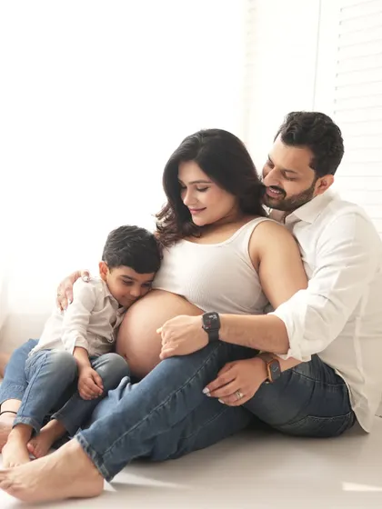 Sometimes the most powerful photos are the quietest. This intimate family moment, with a big brother-to-be listening to the baby bump, is a perfect example of the relaxed, heartfelt memories we can create together.