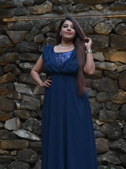 Another pose in my elegant navy gown, showcasing its graceful drape. I choose outfits that allow me to move comfortably while maintaining a strong stage presence.