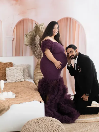 Listening for the first flutters. The dad-to-be kneels to listen to the baby bump in this sweet and intimate moment.