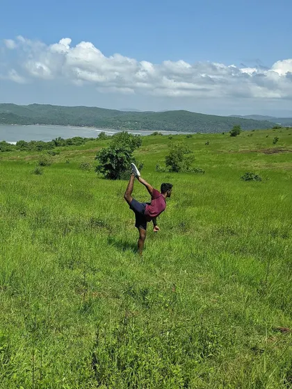 Practicing Natarajasana (Dancer's Pose) in a field in Gokarna. For me, setting a stage for practice is like worshipping the body, finding beauty in the movement and the surroundings.