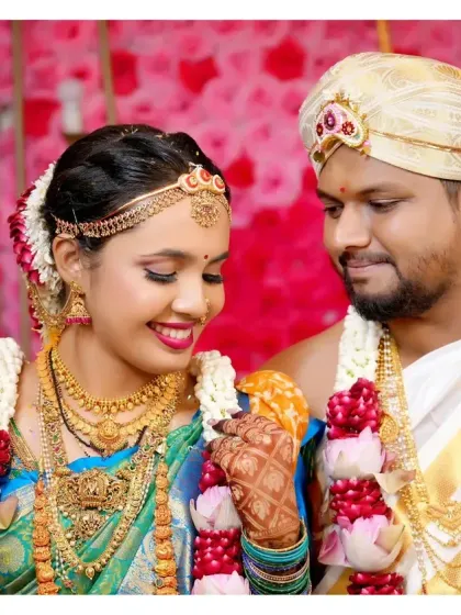 A playful moment during the wedding rituals, where the bride and groom share a lighthearted interaction.