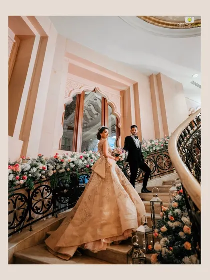 A fairytale moment for Aishwarya and Nikhil on the grand staircase of The Leela Palace Bengaluru. Her makeup was designed to be timeless and elegant, matching the grandeur of her ball gown and the romantic setting.