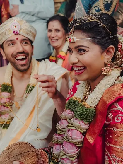 The happiest moments are the most beautiful. This candid shot captures the pure joy of Sahana and her groom during their Muhurtham ceremony.