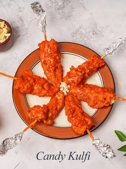 A playful and delicious starter, our Candy Kulfi is savory chicken shaped like a kulfi candy. The chicken is minced, seasoned, molded onto sticks, and cooked, then wrapped in foil for a fun presentation.