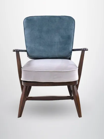 The front view of the mahogany armchair, showing the contrast between the two cushion colors and the dark wood frame.