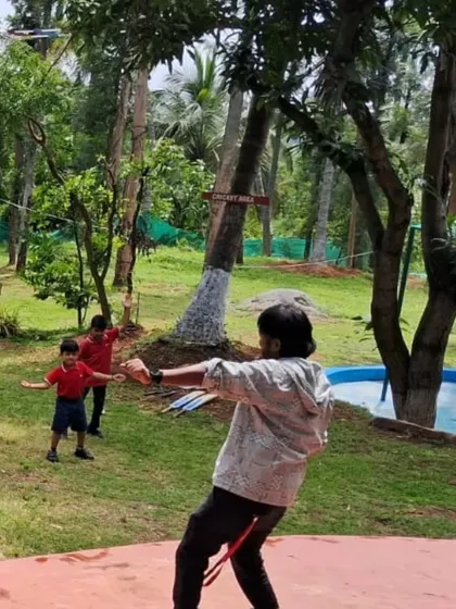Safety and learning go hand in hand during our adventure activities. Here, one of my trained instructors is guiding a student through a target practice session, ensuring they have fun while learning a new skill in a controlled environment.