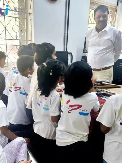 A post office official explains the process to an attentive group of children. We are grateful to our community partners for these valuable learning opportunities.