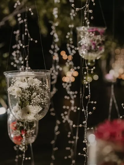 Hanging glass terrariums with baby's breath, creating a delicate and magical effect.