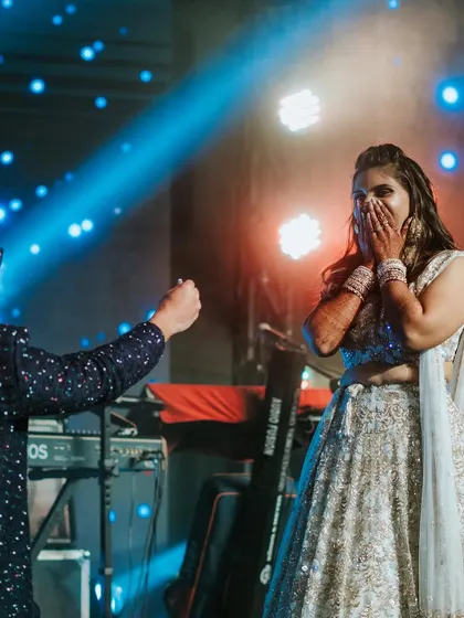 The surprise proposal during the Sangeet. The bride's reaction is priceless as the groom gets down on one knee on stage.