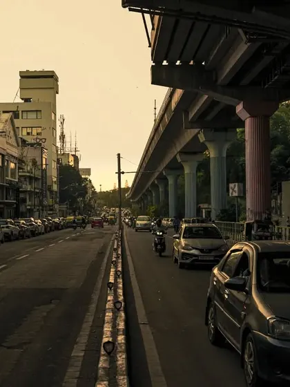 A wide shot of a busy Bangalore street under the metro line. This image captures the scale and constant motion of the city, a theme I often explore in my urban photography.