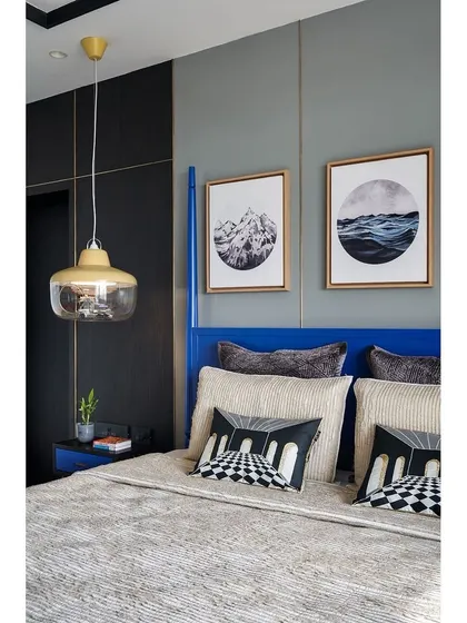 A detail shot of the son's bed, showing the custom cushions and the layering of textures that add depth and comfort.