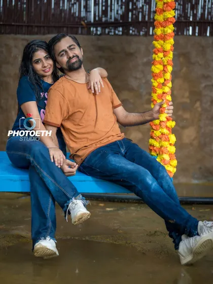 A casual and relaxed portrait of the couple on a blue swing. This kind of simple, candid moment is a beautiful addition to any pre-wedding album.