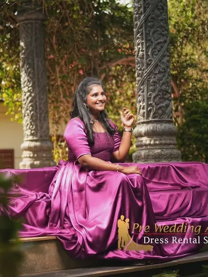 The rich magenta satin of this trail gown creates a luxurious feel. Here, the fabric is draped over steps for a regal, seated portrait.