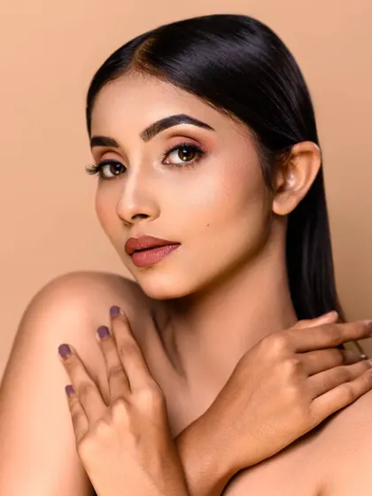 A clean and simple beauty shot, perfect for showcasing the makeup artist's skill in creating a flawless, natural-looking base and defined features.