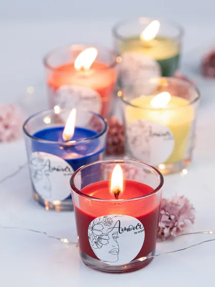 My shot glass candles, lit and glowing. The vibrant colors create a captivating and calming ambiance, making them a home essential for fragrance lovers.